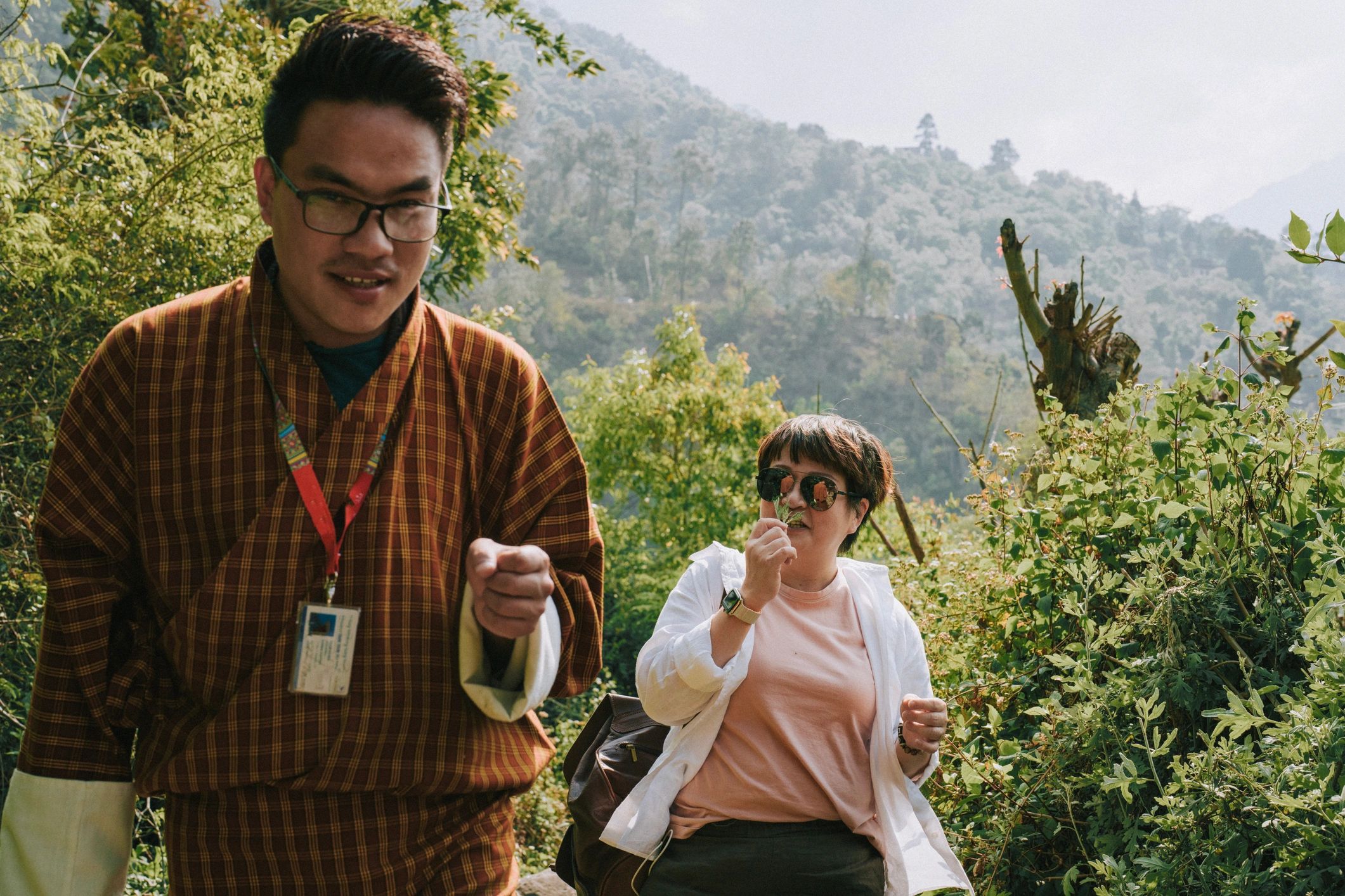 Traveler walking with Bhutanese guide in a park setting