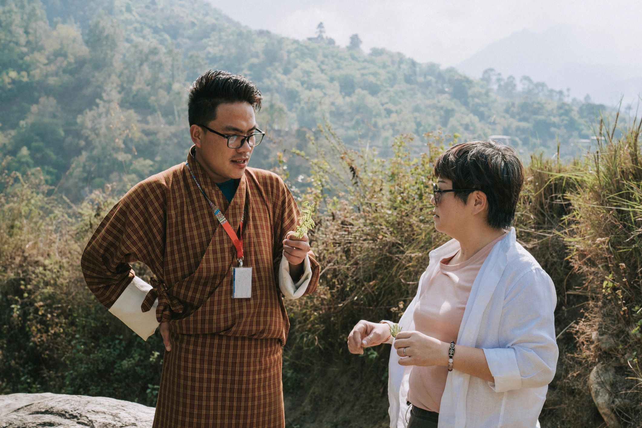 Bhutanese guide with traveler during a cultural hiking journey