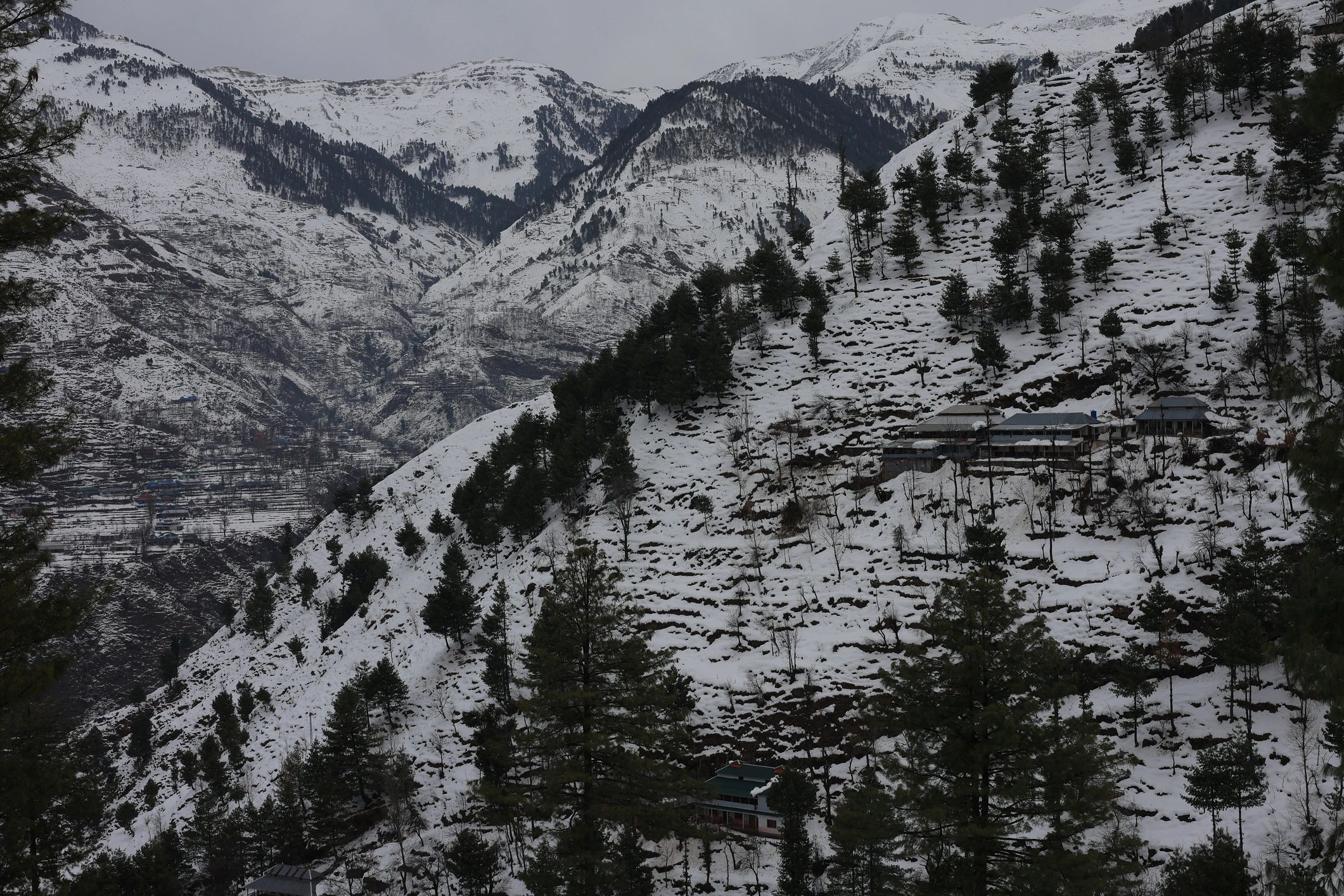 Snowy Himalayan peaks above a serene mountain village